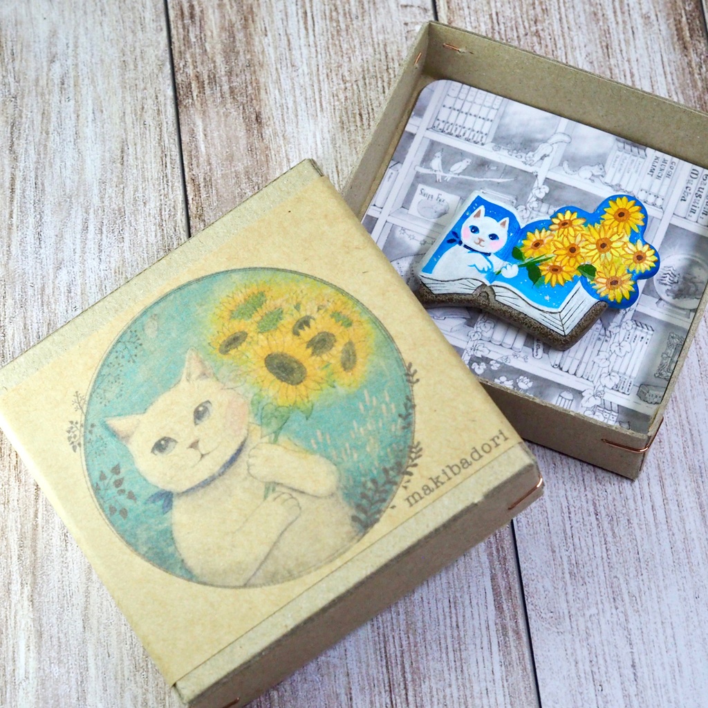 絵本ブローチ《ヒマワリの君に〜白猫》【手描きイラスト・陶土ブローチ】
