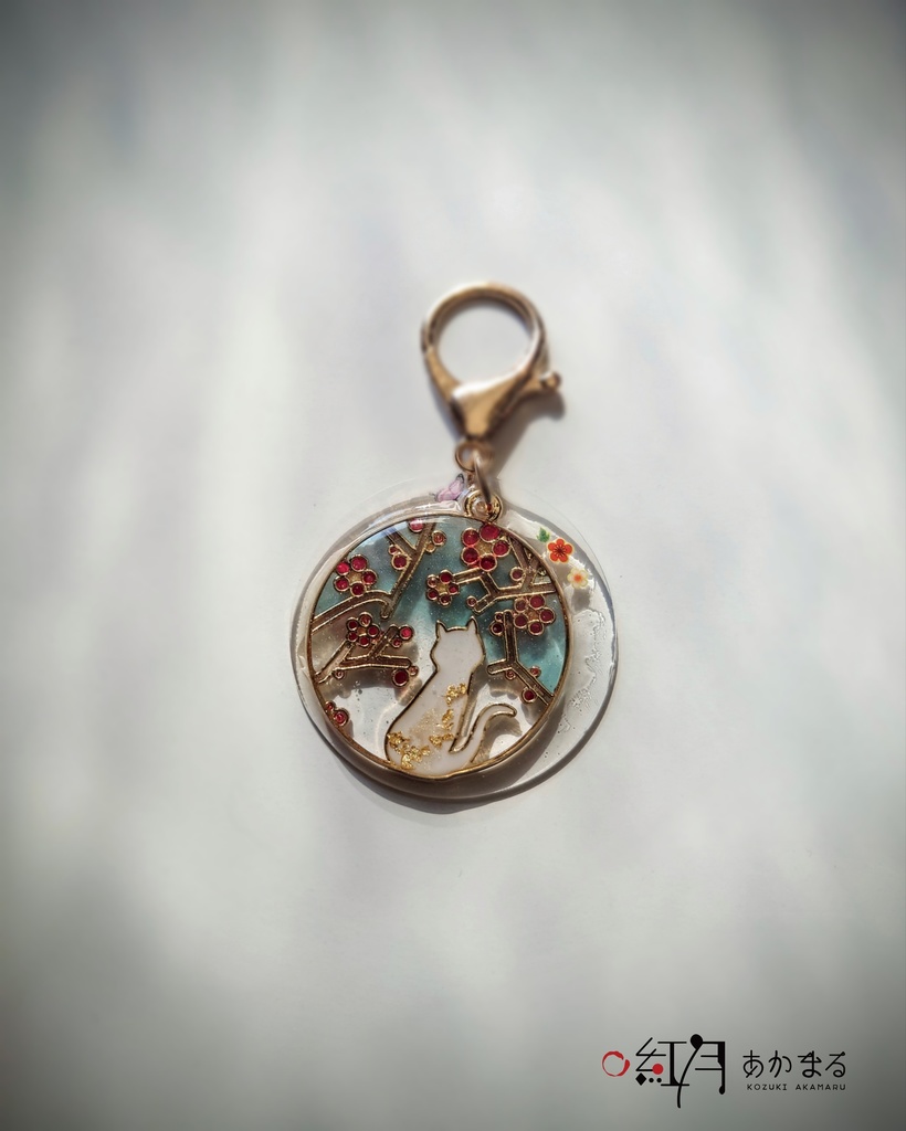 『梅を眺める猫』