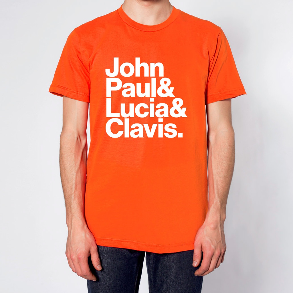 「ジョン・ポール&ルツィア&クラヴィス.」T シャツ (Orange)