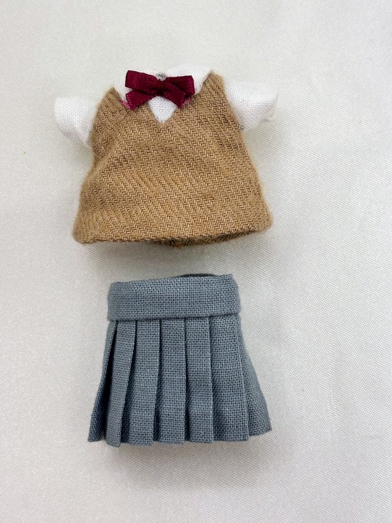 臙脂のリボンのベストとグレーのスカート