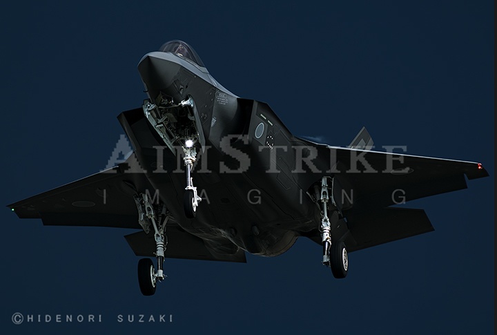 302SQ F-35A in front of dark curtain