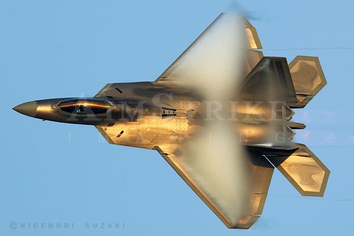 F-22 Raptor shining gold color  in late evening sky