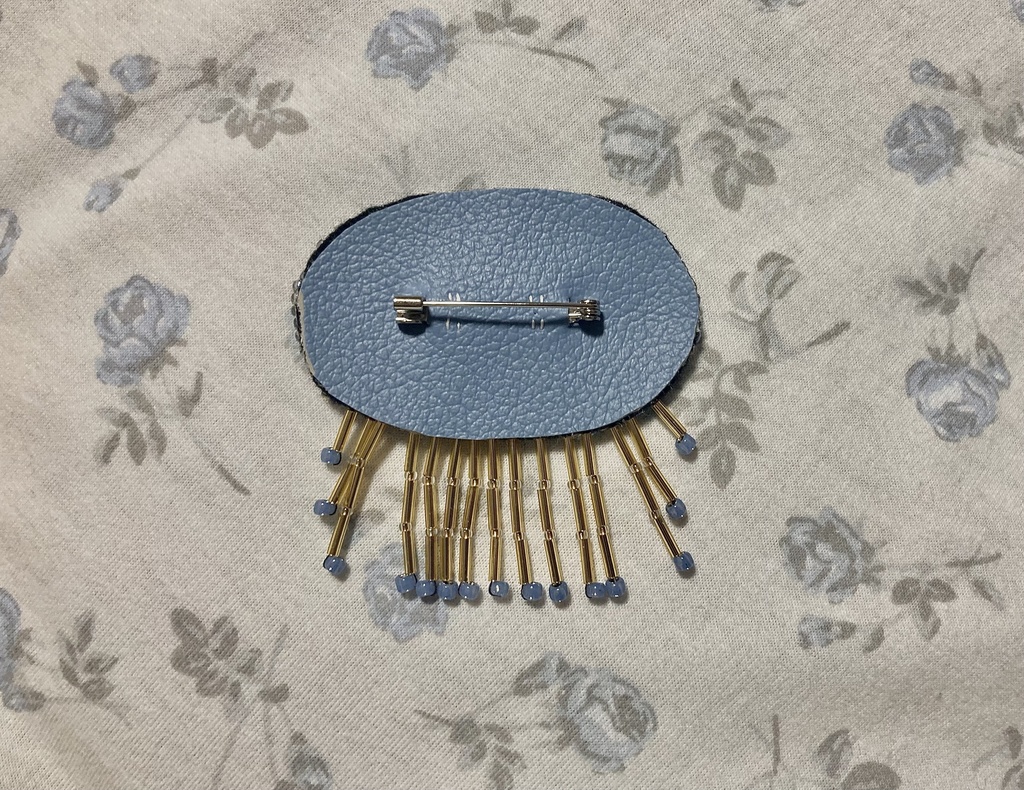 Unicorn fossil brooch