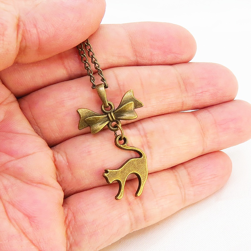 アンティークゴールド 跳ね猫とリボンのモチーフを組合せたコンパクトで大人可愛いネックレス 長さ変更可 アジャスター可