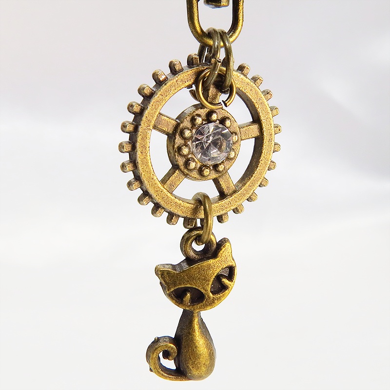 アンティークゴールド 猫と歯車を組合せた可愛いキーホルダー スワロフスキー・クリスタル バッグチャーム ファスナーチャーム