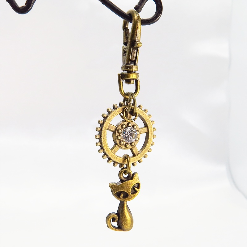 アンティークゴールド 猫と歯車を組合せた可愛いキーホルダー スワロフスキー・クリスタル バッグチャーム ファスナーチャーム