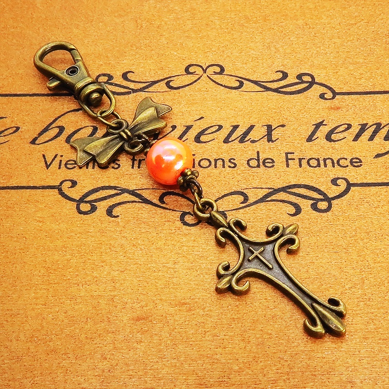 アンティークゴールド ロザリオとリボンの組み合わせにオレンジミックスビーズキーホルダー ファスナーチャーム