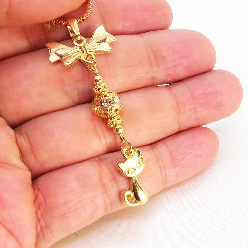 マットゴールド 猫とリボンのネックレス ガラス入りメタルビーズ ベネチアンチェーン アジャスター可