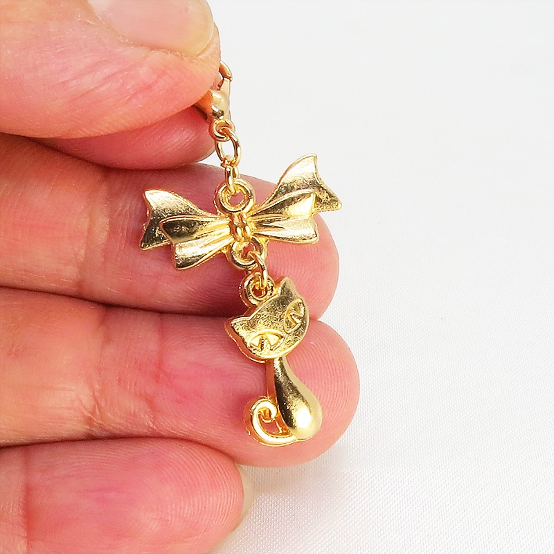 マスク・スマホチャーム マットゴールド 猫モチーフとリボンのコンパクトで可愛いチャーム ジャックピン追加可