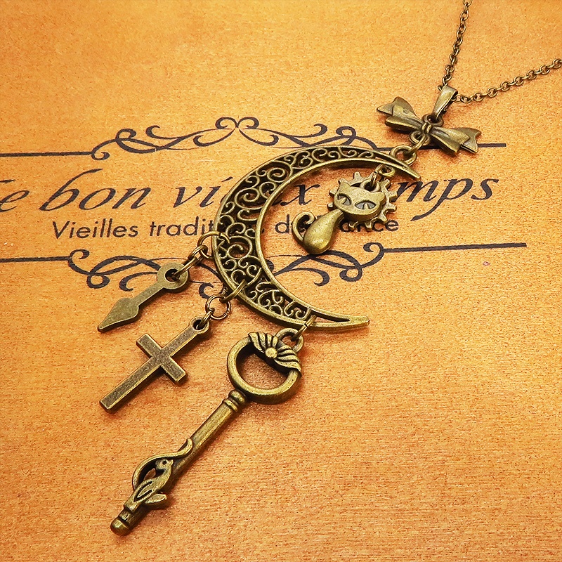 アンティークゴールド 猫とアラベスク調の透かし模様の入った三日月のネックレス リボン 鍵 ロザリオ 時計の針 長さ調整可