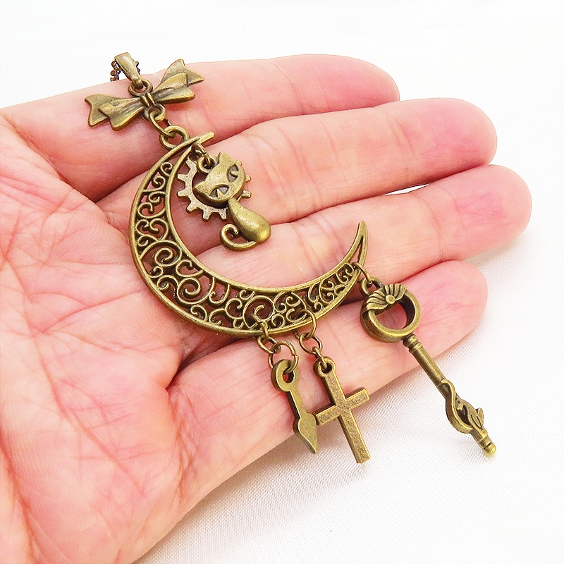 アンティークゴールド 猫とアラベスク調の透かし模様の入った三日月のネックレス リボン 鍵 ロザリオ 時計の針 長さ調整可