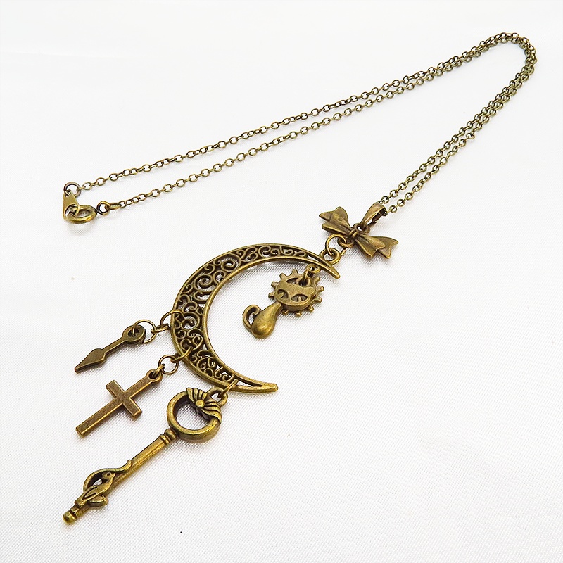 アンティークゴールド 猫とアラベスク調の透かし模様の入った三日月のネックレス リボン 鍵 ロザリオ 時計の針 長さ調整可