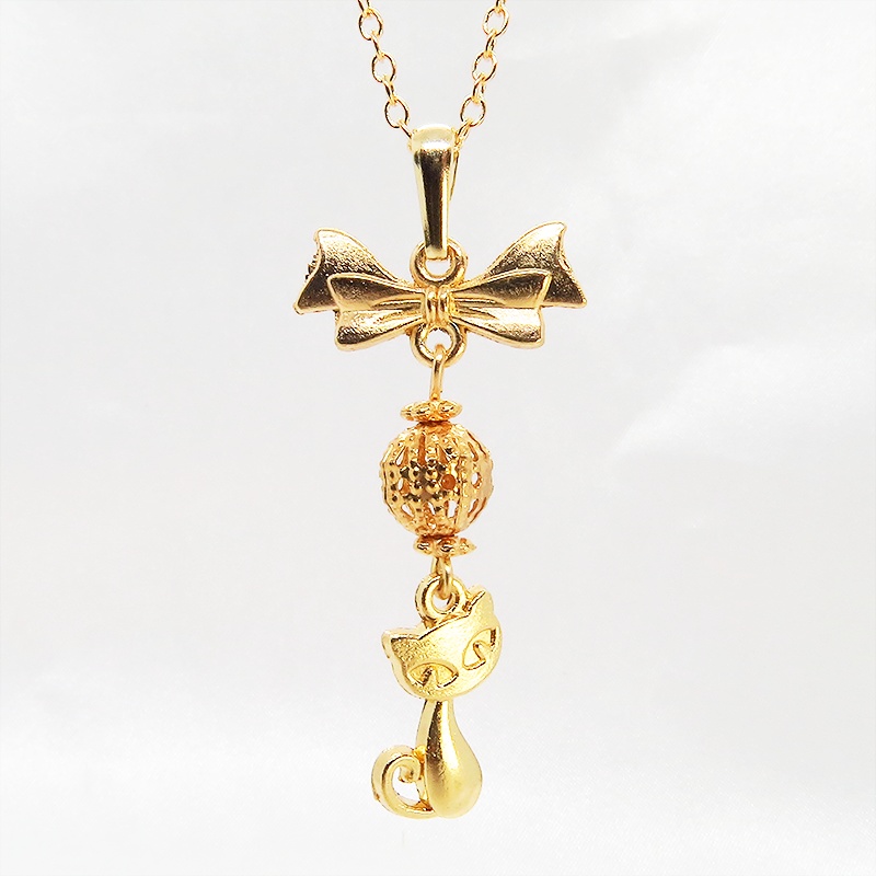 マットゴールドの猫とリボンと透かしメタルビーズのチャームのネックレス