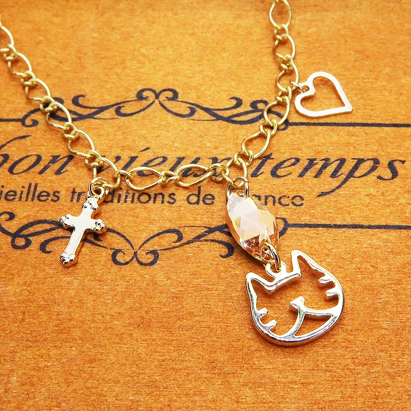 猫フェイスシルエットモチーフと大きめスワロフスキー(ゴールドシャドー)のブレスレット ゴールドカラー ロザリオ ハート