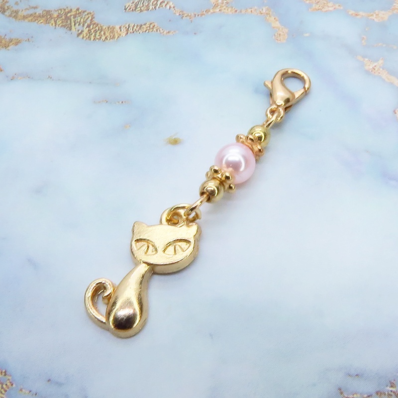 マスクチャーム マットゴールドの猫モチーフとスワロフスキーパール(ロザリン)を組み合わせた可愛いチャーム キーホルダー