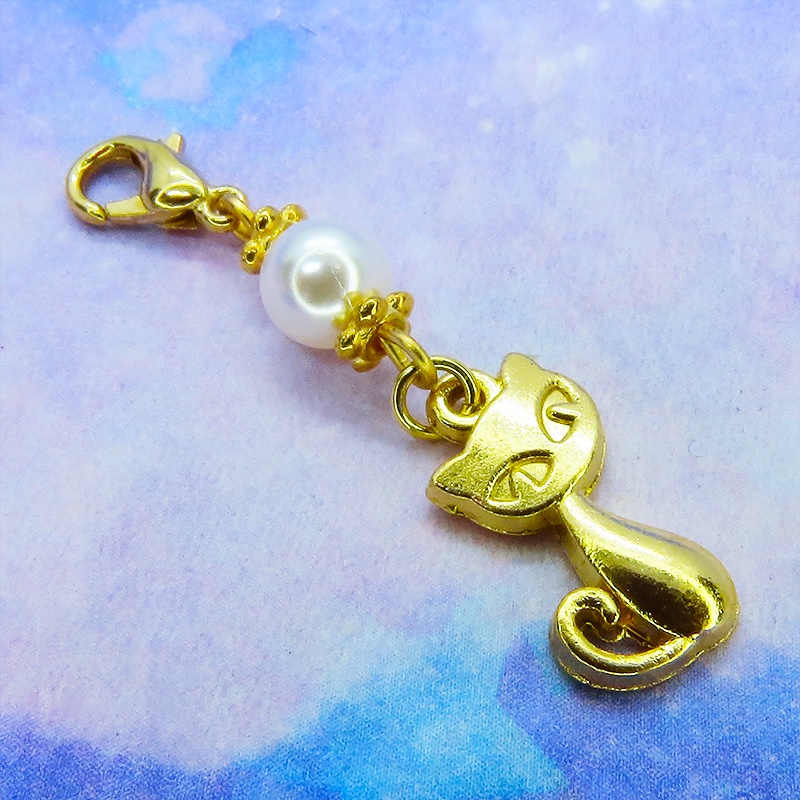 マスクチャーム マットゴールドの猫モチーフとスワロフスキーパール(クリスタルホワイト)のチャーム キーホルダー