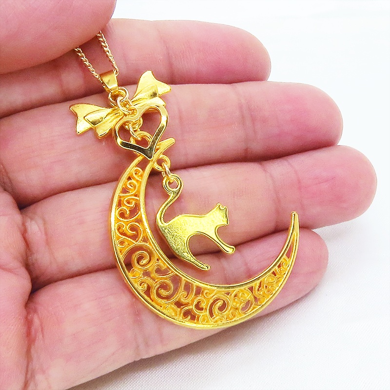 ゴールドカラーの跳ね猫と透かし三日月の大人可愛いネックレス ムーンネックレス リボン ハート