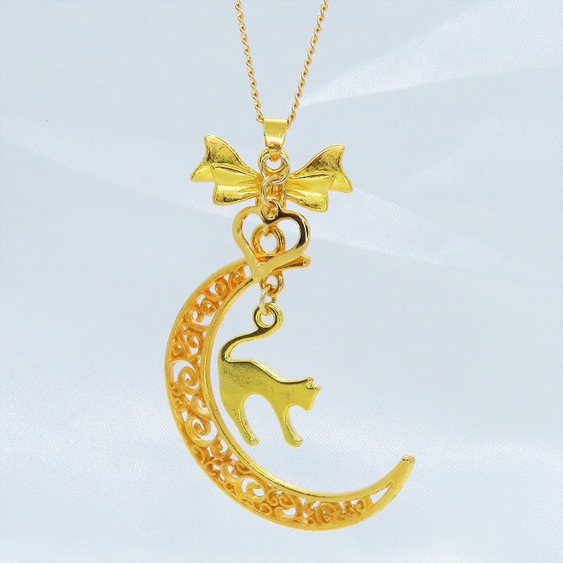 ゴールドカラーの跳ね猫と透かし三日月の大人可愛いネックレス ムーンネックレス リボン ハート