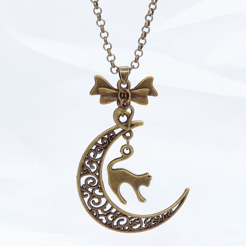 アンティークカラーの跳ね猫と透かし三日月の大人可愛いネックレス ムーンネックレス リボン ハート 金古美色