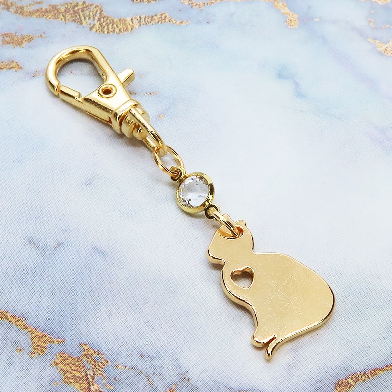 ゴールドカラー 猫シルエットモチーフとラインストーンのキーホルダー バッグチャーム シンプル クリア