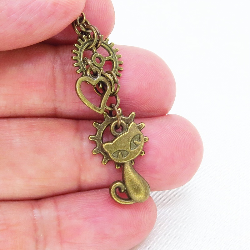 アンティークゴールド 猫と異なる歯車を組合せたスチームパンク風ピアス オープンハート