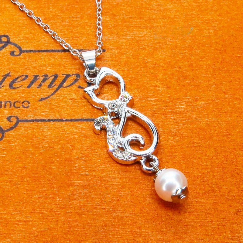 ラインストーンが輝くシルバーカラーの猫モチーフとスワロフスキーパール(クリスタルホワイト)の可愛いペンダントネックレス