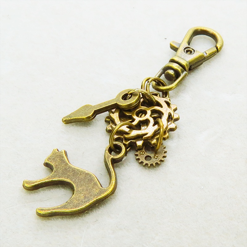 アンティークゴールド 跳ね猫と歯車を組み合わたコンパクトなスチームパンク風キーホルダー バッグチャーム