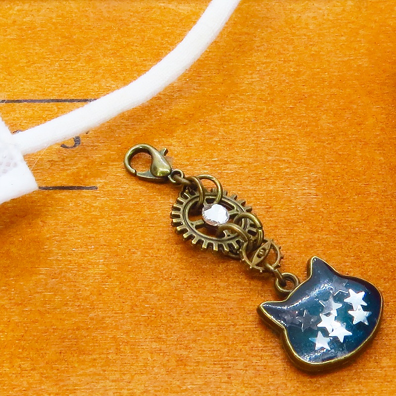 マスク・スマホチャーム ブルーキャットスター 青い猫フェイスに星を散りばめたチャーム アンティークゴールド 歯車 金具変更可