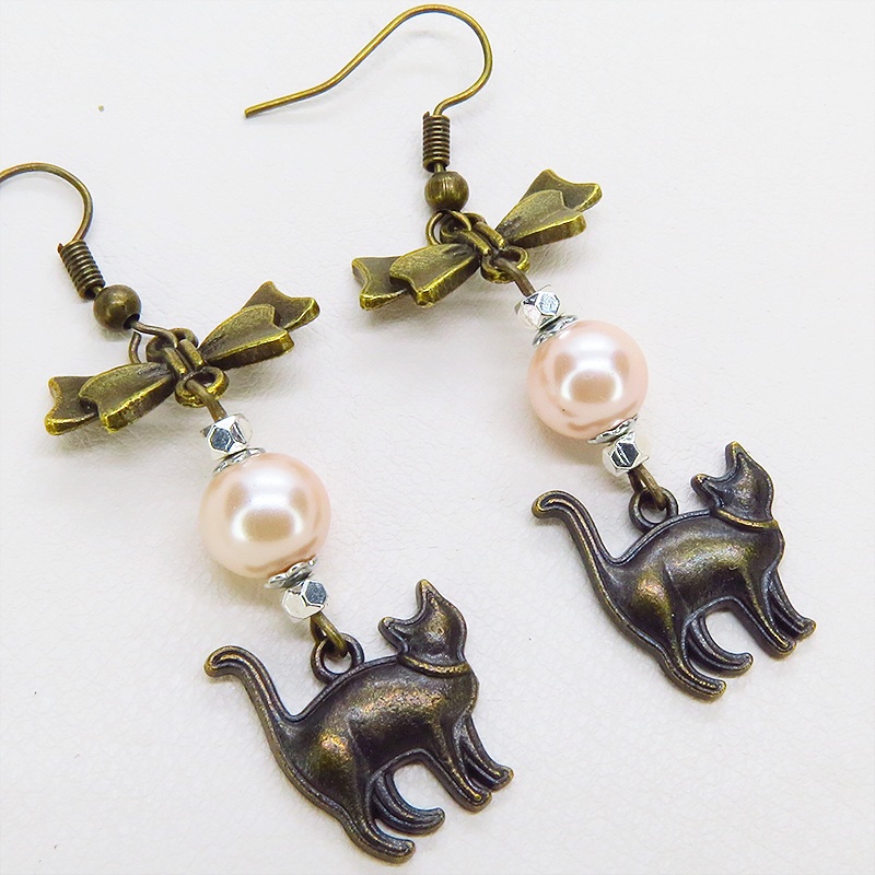 アンティークゴールド 歩き猫とリボンにベージュカラーのビーズを組合せた大人可愛いピアス サージカル可