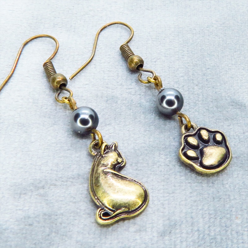 アンティークゴールド 振り向き猫と肉球のアシンメトリーピアス スワロフスキーパール(ブラック)