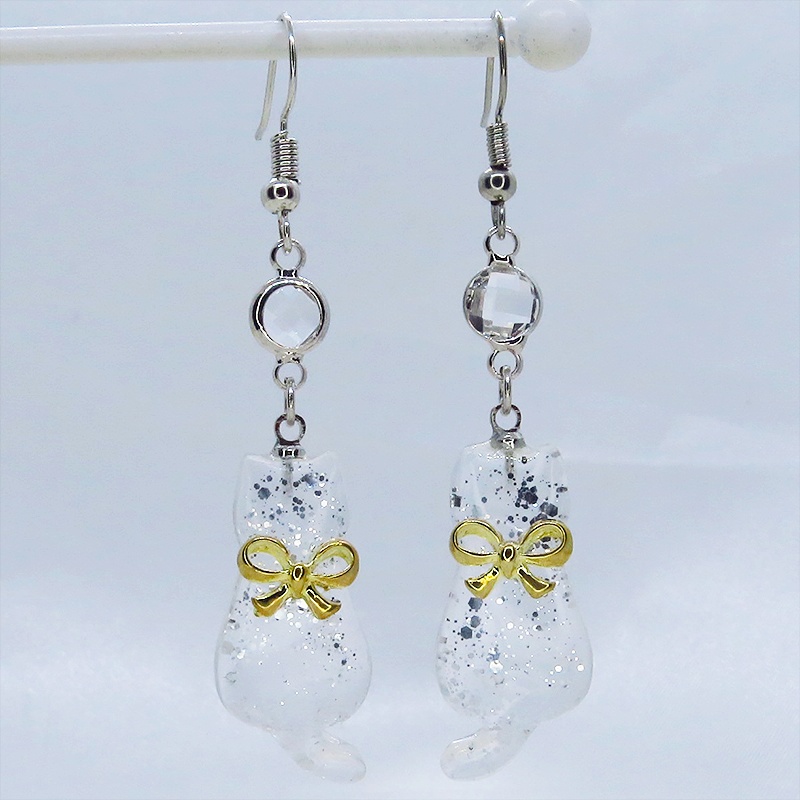 ゴールドカラーのリボンを付けたクリアカラーの猫シルエットモチーフのピアス ラインストーン サージカル可