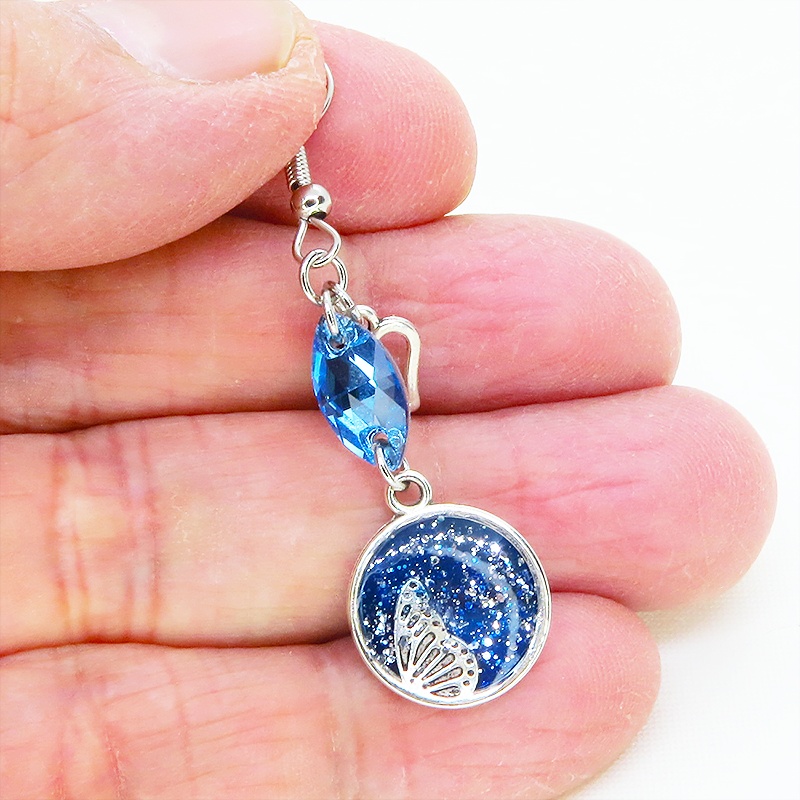 ブルーレジンで彩色した蝶の羽とアクアマリンのスワロフスキーのピアス オープンハート サージカル可