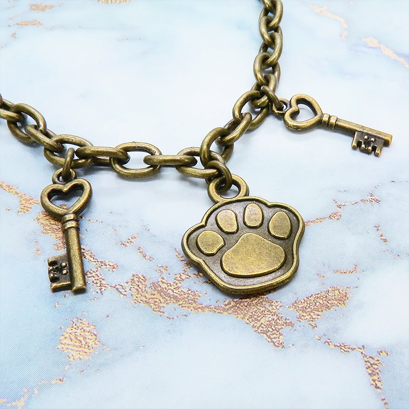 アンティークゴールド 大きめ肉球モチーフと鍵モチーフを組合せたブレスレット