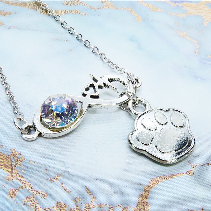シルバーカラー クリスタル(クリア)のエターニティーと肉球モチーフを組合せたネックレス ステンレス可 長さ調整可