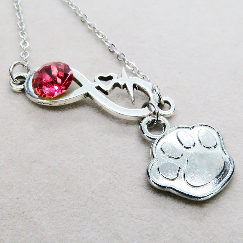 シルバーカラー クリスタル(マゼンタ)のエターニティーと肉球モチーフを組合せたネックレス ステンレス可 長さ調整可