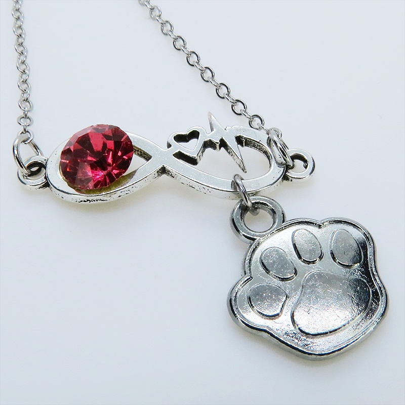 シルバーカラー クリスタル(マゼンタ)のエターニティーと肉球モチーフを組合せたネックレス ステンレス可 長さ調整可