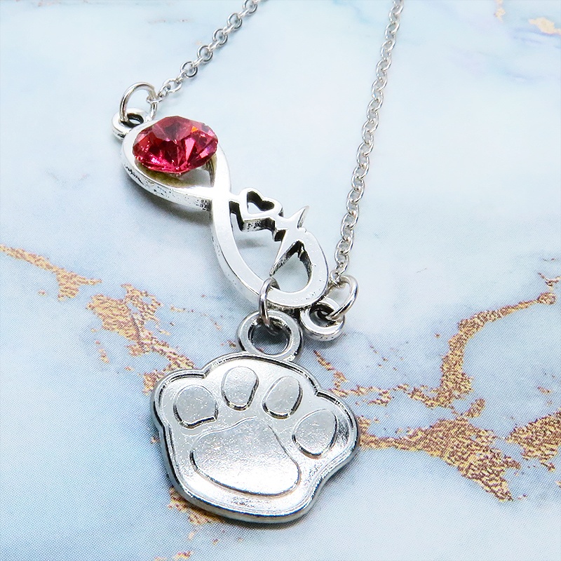 シルバーカラー クリスタル(マゼンタ)のエターニティーと肉球モチーフを組合せたネックレス ステンレス可 長さ調整可