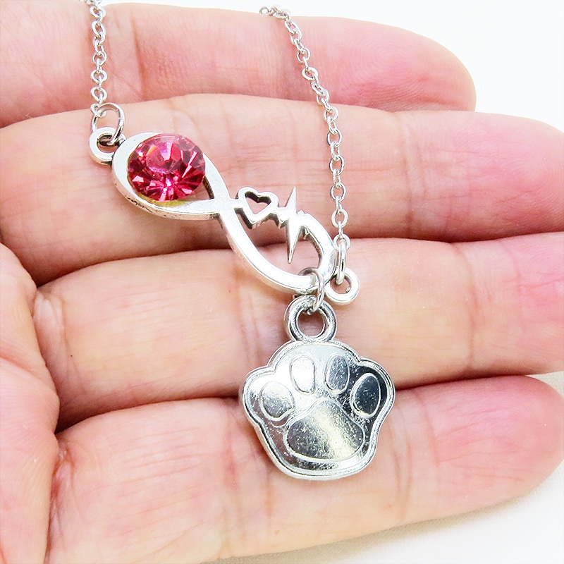 シルバーカラー クリスタル(マゼンタ)のエターニティーと肉球モチーフを組合せたネックレス ステンレス可 長さ調整可