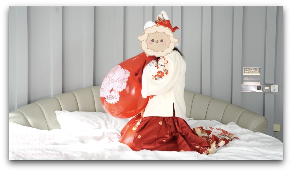 兎年賀喜猫猫餅目隠しして風船を吹いて、遊んで風船を爆発させます