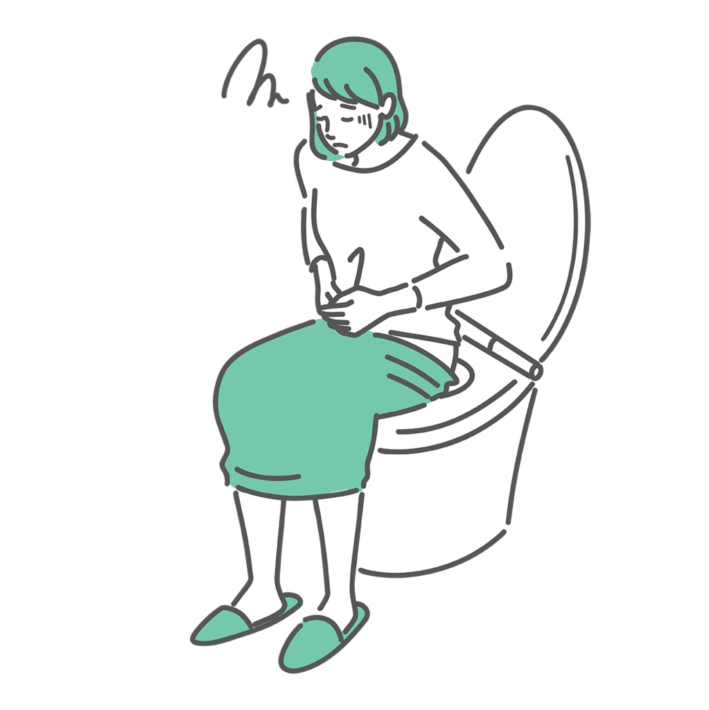 トイレの便座に座って体調が悪そうな女性